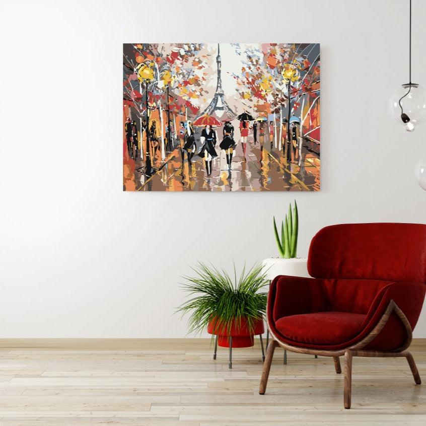 a red chair in front of a painting on a wall